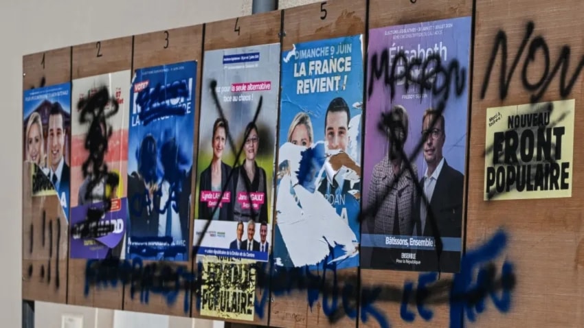 صور المرشحين للانتخابات التشريعية الفرنسية على إحدى الجدران في شمال غرب فرنسا (وكالات)