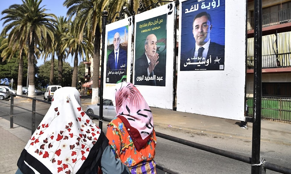 لافتات للمرشحين الرئاسيين في الجزائر (من اليسار) عبد الله حسن شريف، وعبد المجيد تبون، ويوسف عوشيش (أسوشيتد برس)