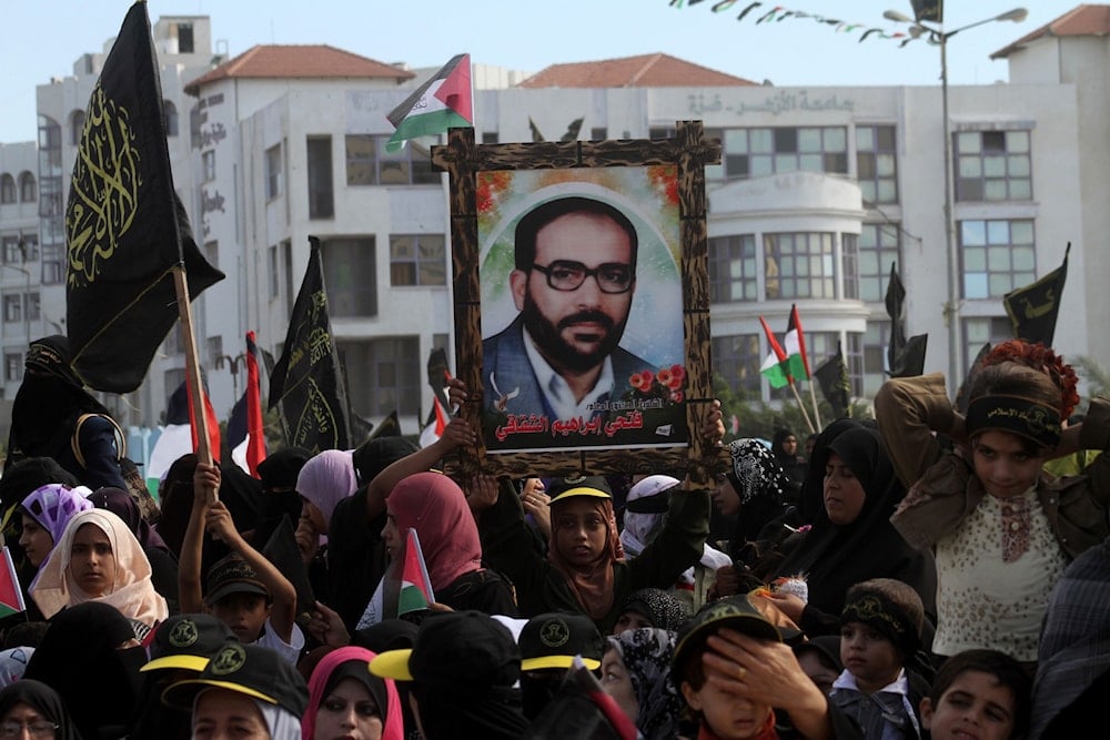 فلسطينيون يرفعون صورة الأمين العام المؤسس لحركة الجهاد الإسلامي الشهيد الدكتور فتحي الشقاقي في قطاع غزّة (مواقع فلسطينية)